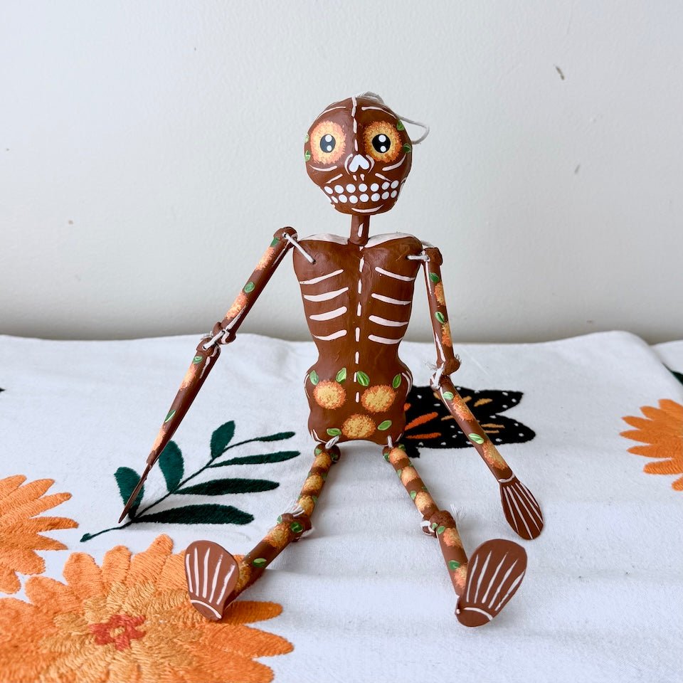 Brown Paper Mache Skeleton with Cempasuchil Flowers
